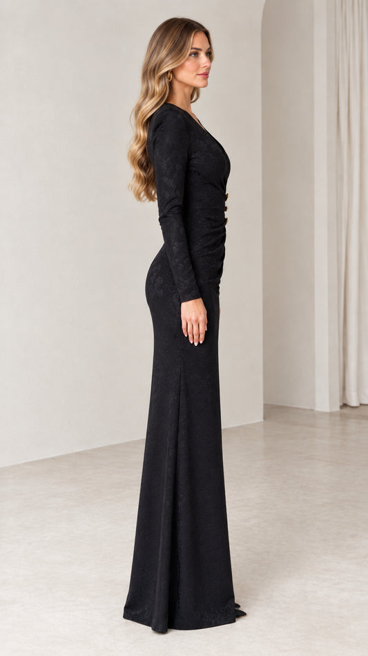 Side profile of woman wearing black long sleeve floor-length formal dress