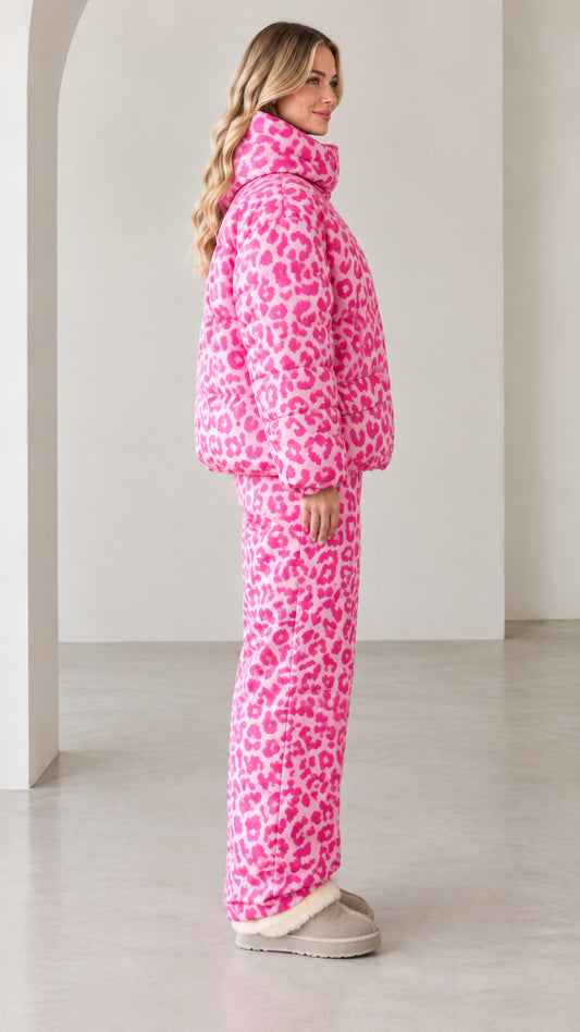 Side profile view of model in pink leopard print insulated puffer tracksuit