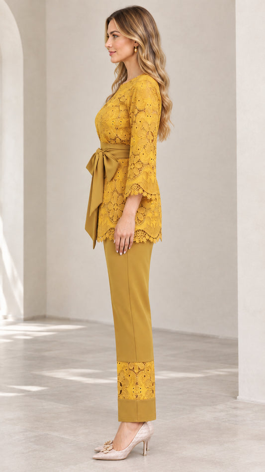 Side view of woman in mustard yellow 2-piece lace pant suit