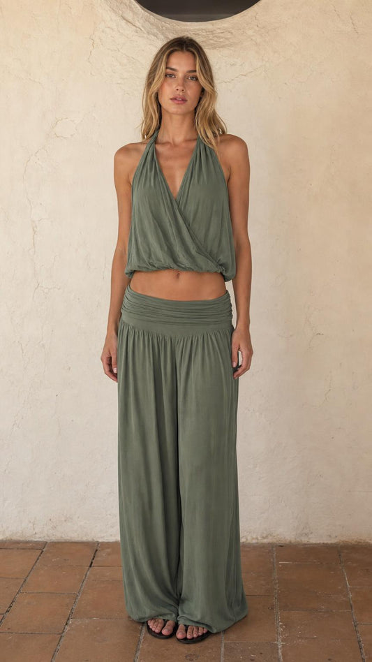 Front view of woman wearing sage green halter crop top and wide leg pants set