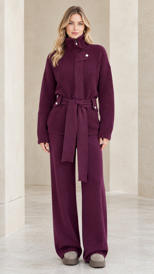 Front full-length view of woman wearing plum ribbed knit belted sweater and matching wide-leg pants set