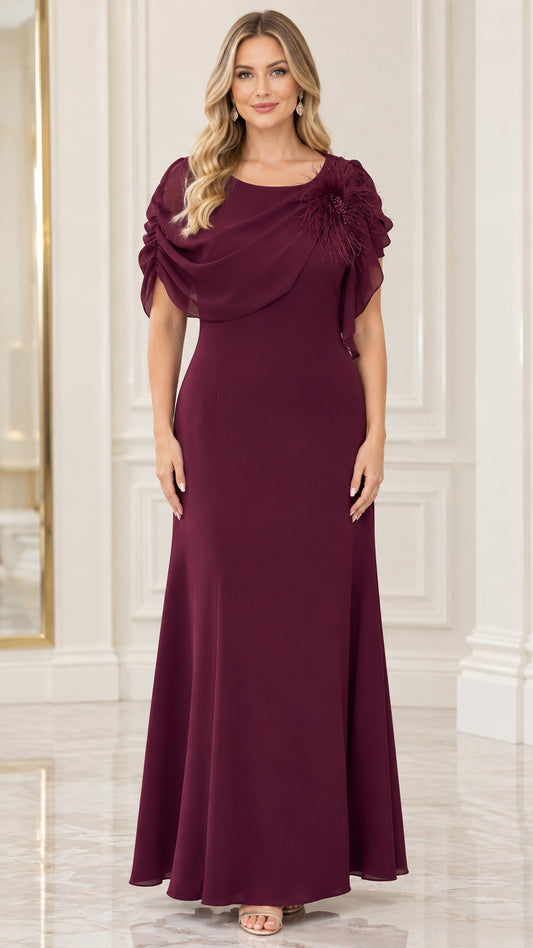 Front view of model wearing burgundy draped chiffon maxi evening dress with feather floral shoulder detail